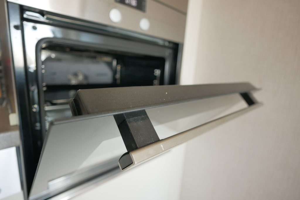 A built-in oven part open, seen along the handle