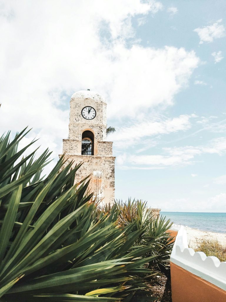 The Worth Avenue clock tower in Palm Beach, with the ocean beyond it