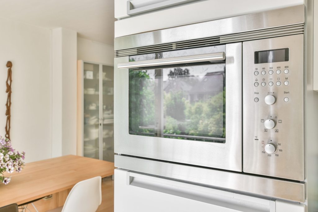 A built-in microwave in a cabinet run, its keypad and door seen square on