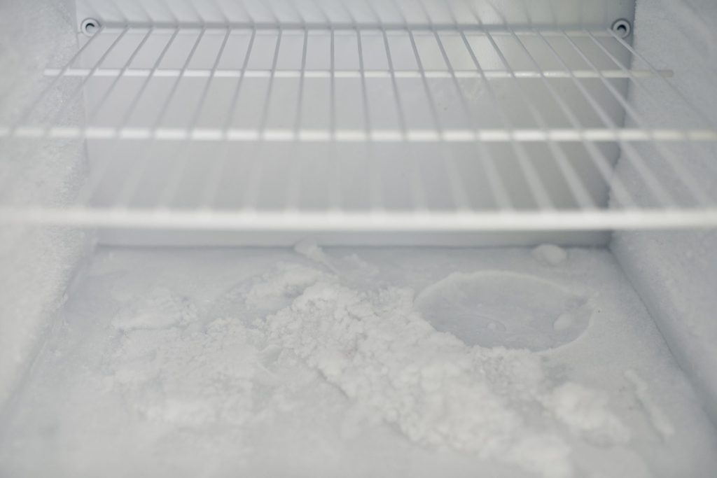 Frost forming across a wire shelf inside a cold compartment